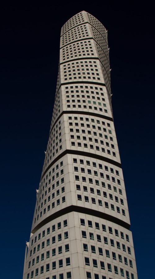 A vertical shot of the Ankarparken skyscraper with a dark blue sky in the background